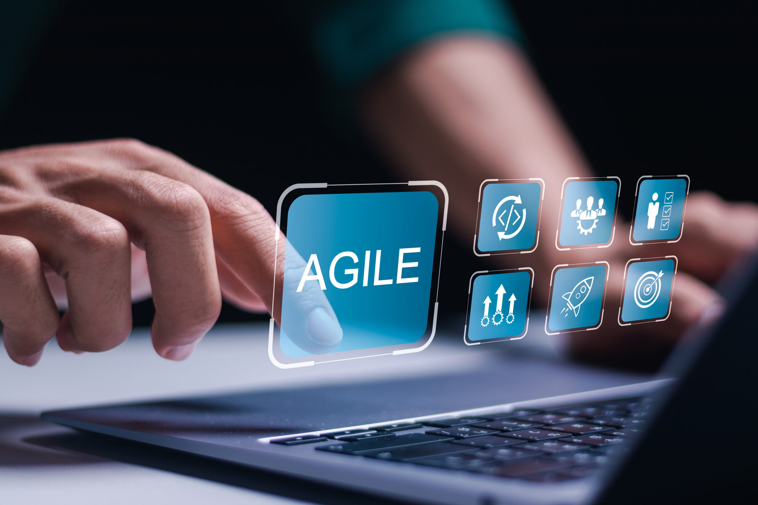 Agile development methodology, businessman use laptop with virtual screen of agile icon for process that will help you work faster By reducing step-by-step work and focusing on team communication.